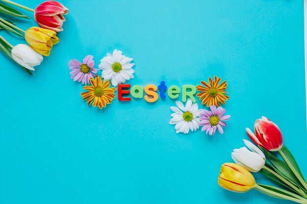 Word Easter in arrangement with flowers