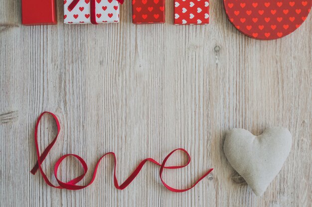 Word "love" with gifts upstairs and a white fabric heart next to it