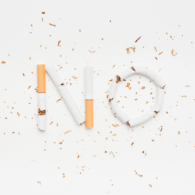 Free photo word no made from broken cigarette with tobacco on isolated on white background