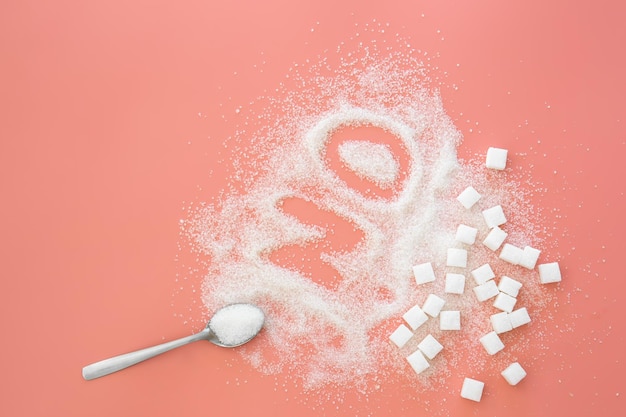 Free photo word no made of sugar and spoon on pink background flat lay