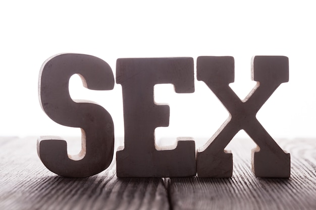 The word sex from wooden letters stand on the table