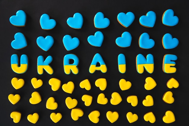 The word Ukraine on a black background made with handmade gingerbread