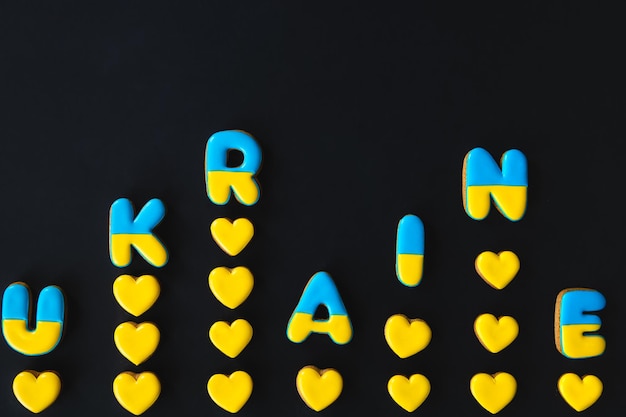 The word Ukraine on a black background made with handmade gingerbread