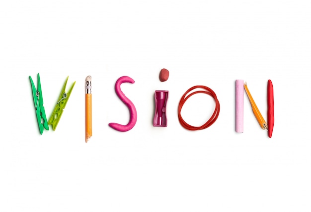 The word vision created from office stationery.