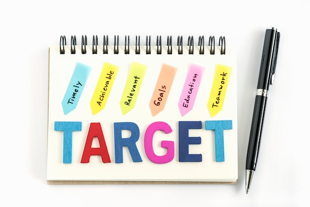 Free photo words target on the notebook with handwriting and pen