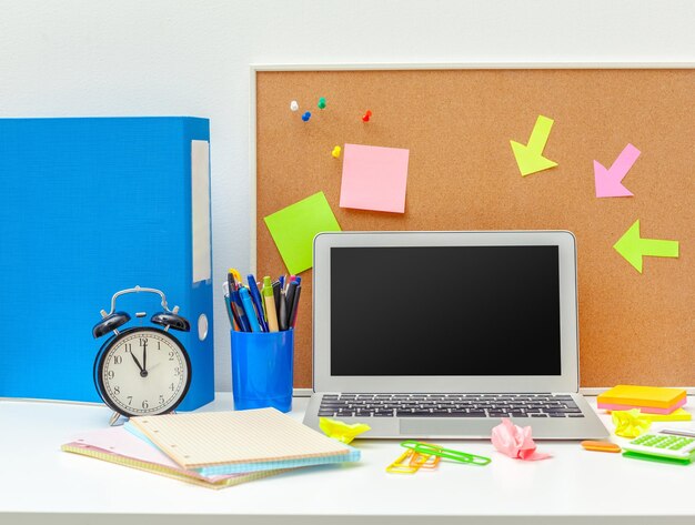 Work place of a creative person with a variety of colorful stationery objects