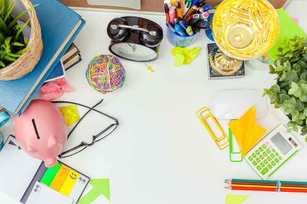 Free photo work place of a creative person with a variety of colorful stationery objects