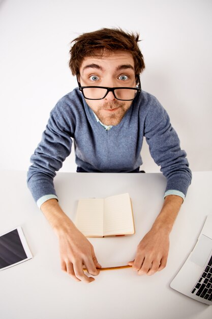 Workaholic, business and office concept. Upper-angle shot of man going crazy at work