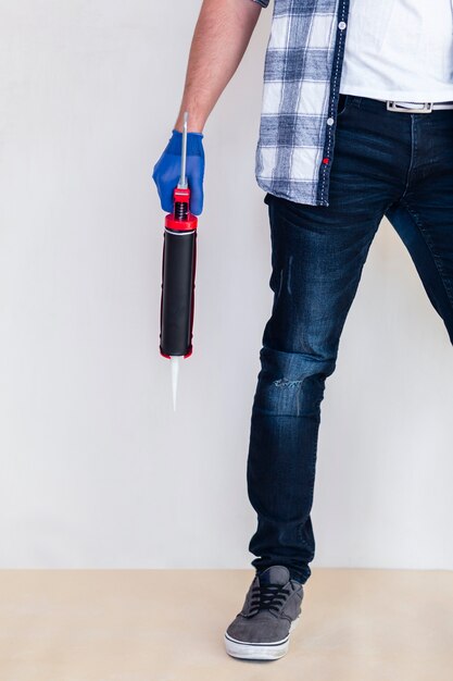 Worker holding a silicone gun