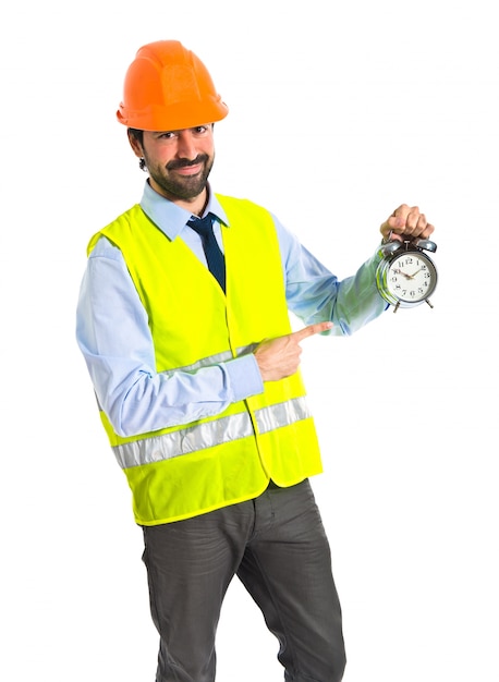 Worker holding vintage clock