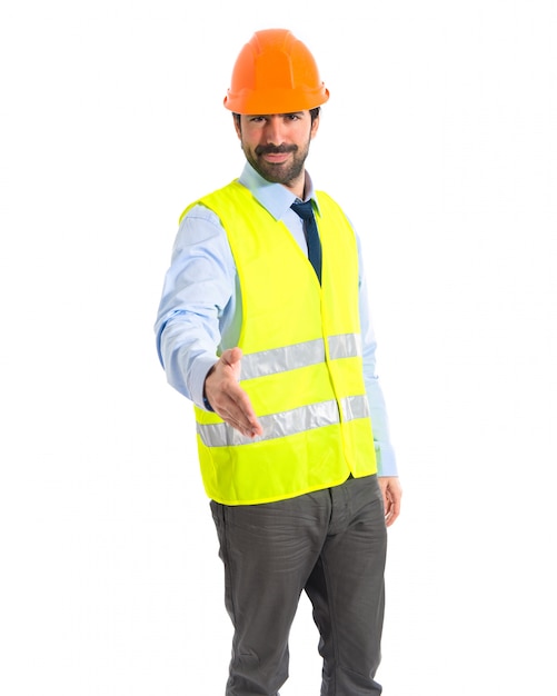 Worker making a deal over white background