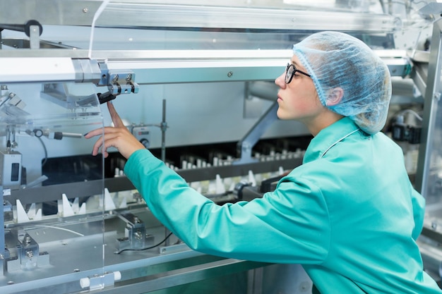 Worker operates the machine at the enterprise clean room with stainless steel hardware