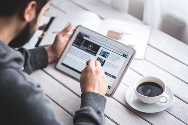 Worker reading news with tablet