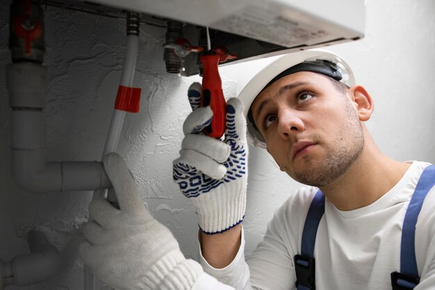 Worker repairing water heater