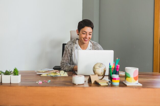 Worker smiling while working with her computer