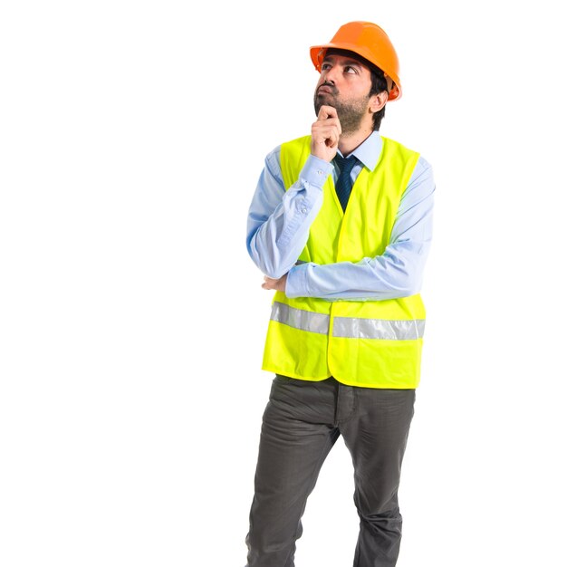 Worker thinking over white background