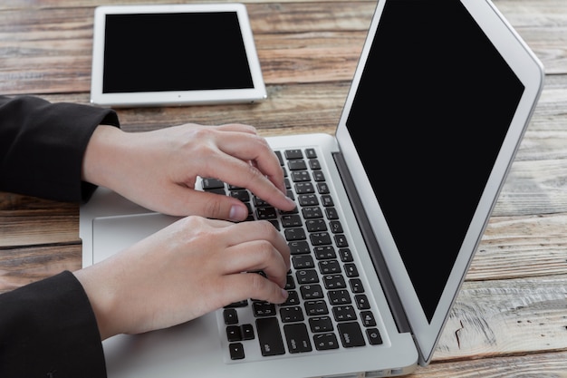 Free photo worker typing on a laptop