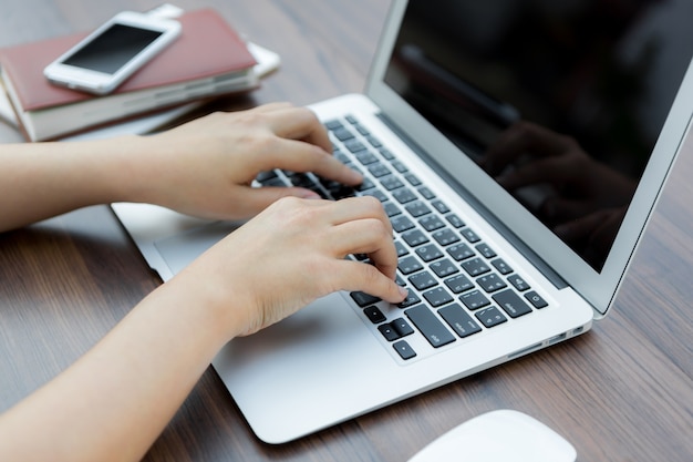 Worker typing on a laptop