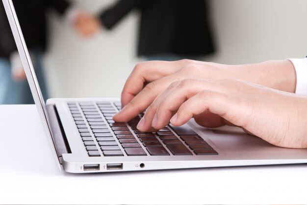 Worker typing on a laptop