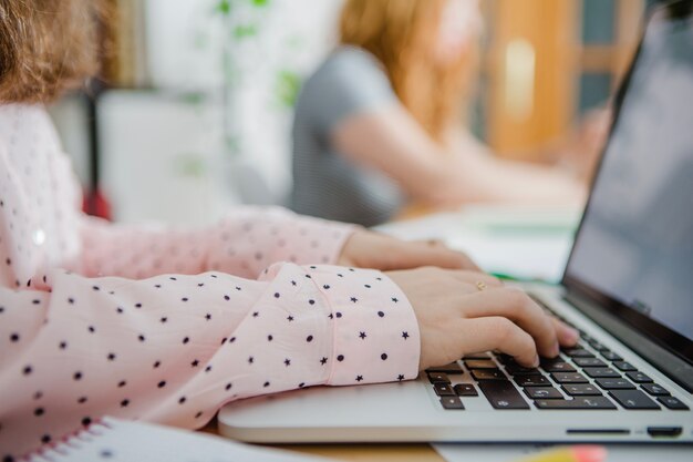 Worker typing on laptop