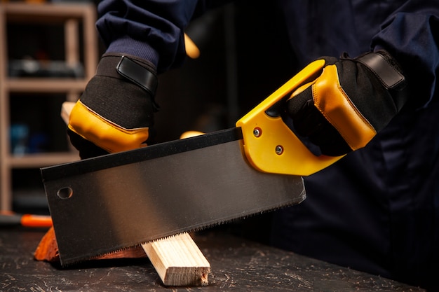 Worker using saw side view