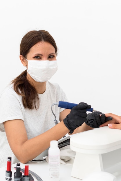 Worker wearing mask at nail salon