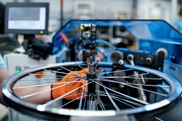Premium Photo - Worker With Machine Tool Checks Bicycle Rim Backlash Factory Bike Wheels Assembly Workshop Cycle Parts Installation 266732 17999