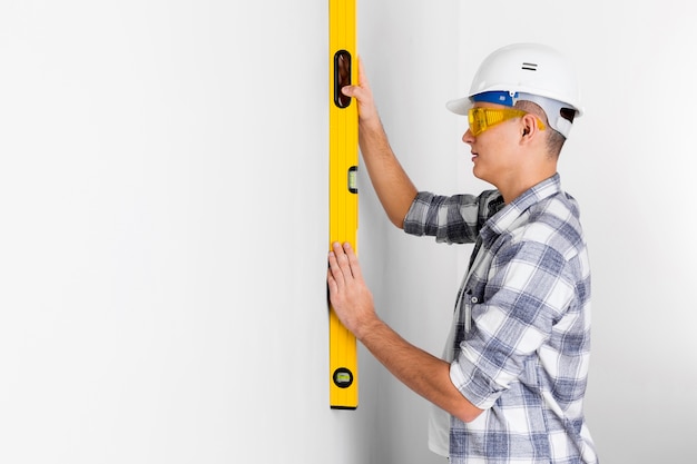 Worker with spirit level with copy space