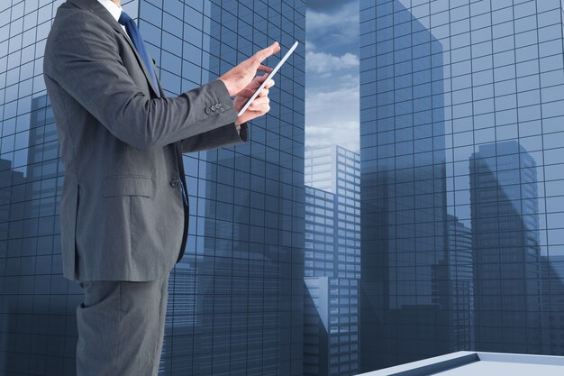 Worker with tablet and office buildings background