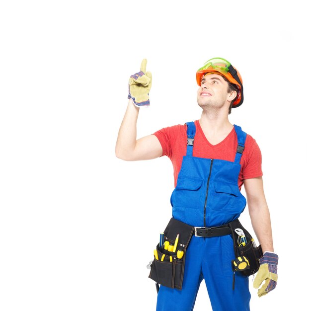 Worker with tools  points up with finher isolated on white