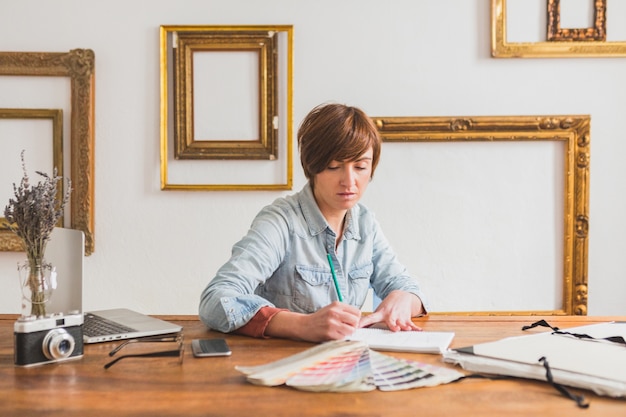 Worker writing in her notebook