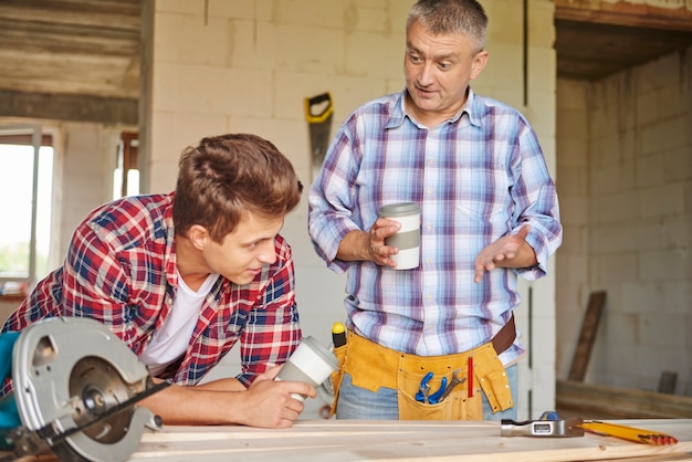 Workers having a little chat while having cup of coffee