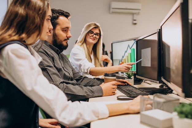 Workers at an IT company working on a computer