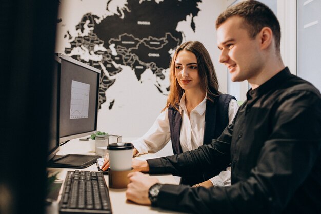 Workers at an IT company working on a computer