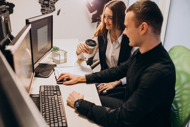 Workers at an IT company working on a computer