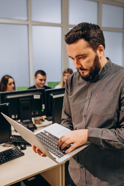 Workers at an IT company working on a computer