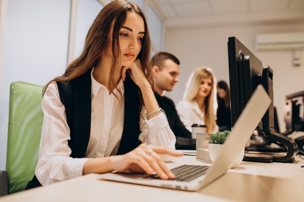 Workers at an IT company working on a computer