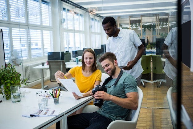 Free photo workers smiling and looking results on paper