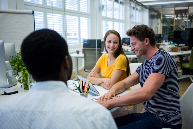 Workers smiling in a white table