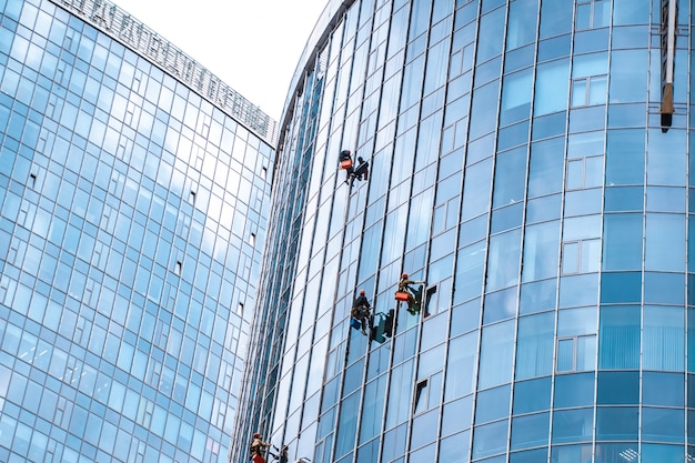 Workers washing windows in the office building