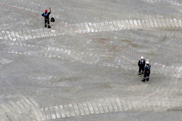 Free photo workers working on the grey area of oil producing