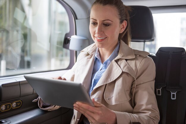 Working businesswoman in the taxi