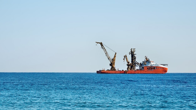 Working industrial cargo ship in the sea