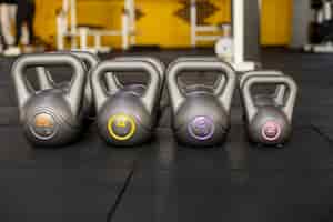 Free photo working out at gym concept with kettlebells