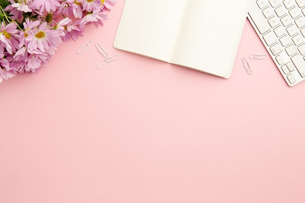 Working woman pink desk with empty notebook