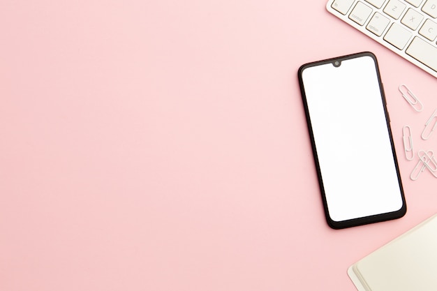 Working woman pink desk with phone and copy space