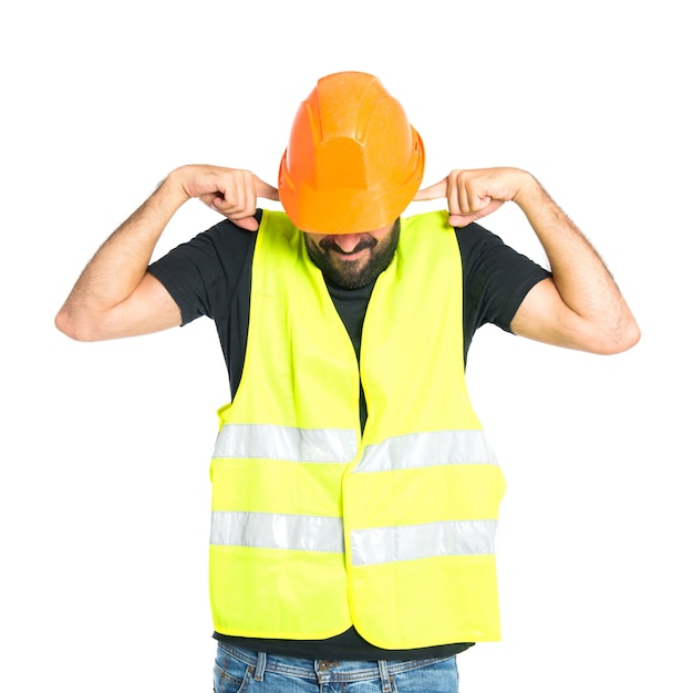 Free photo workman covering his ears over white background