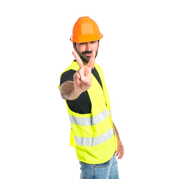 Workman doing victory gesture over white background