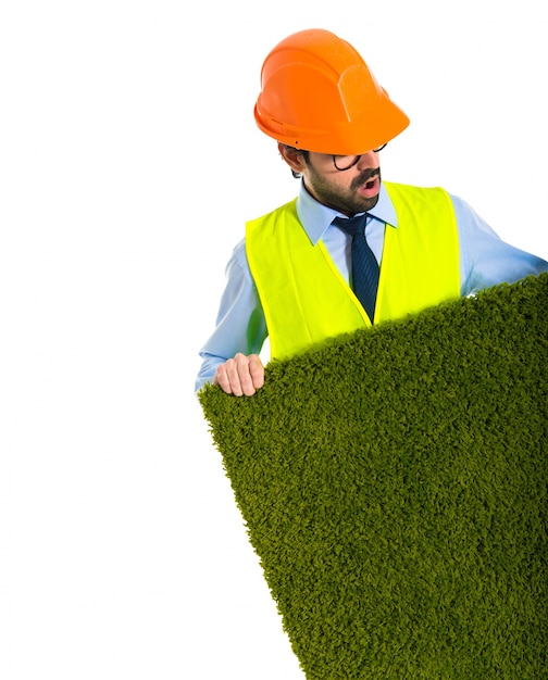 Workman holding grass