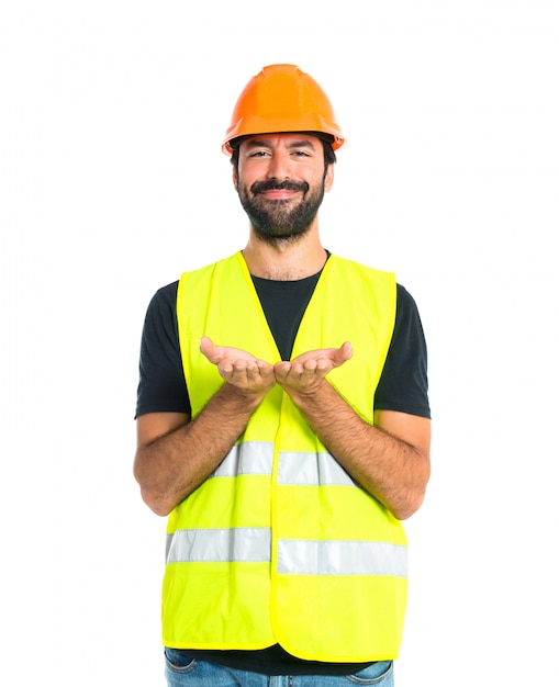 Free photo workman holding something over white background